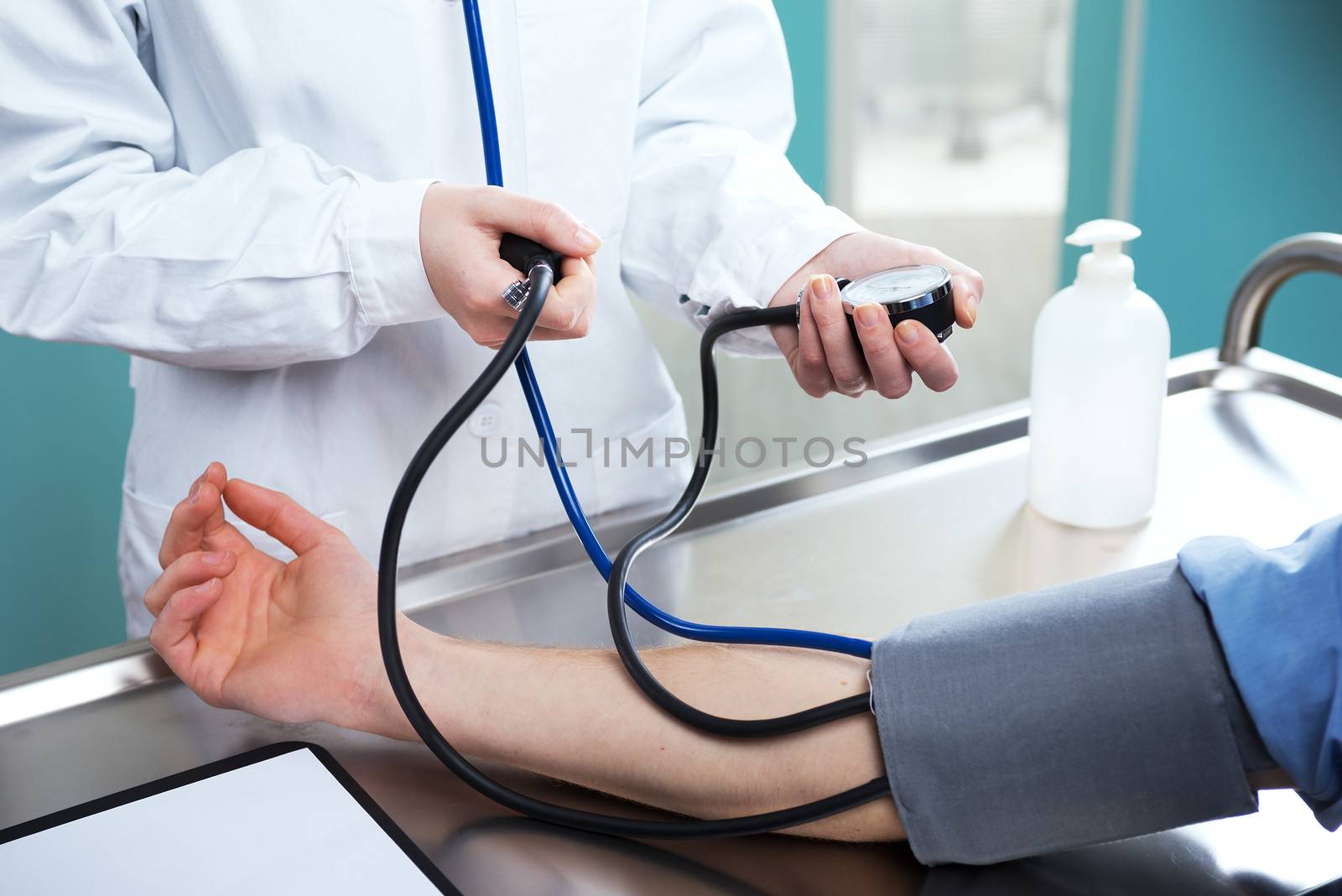 The doctor measures pressure in the patient, close up
