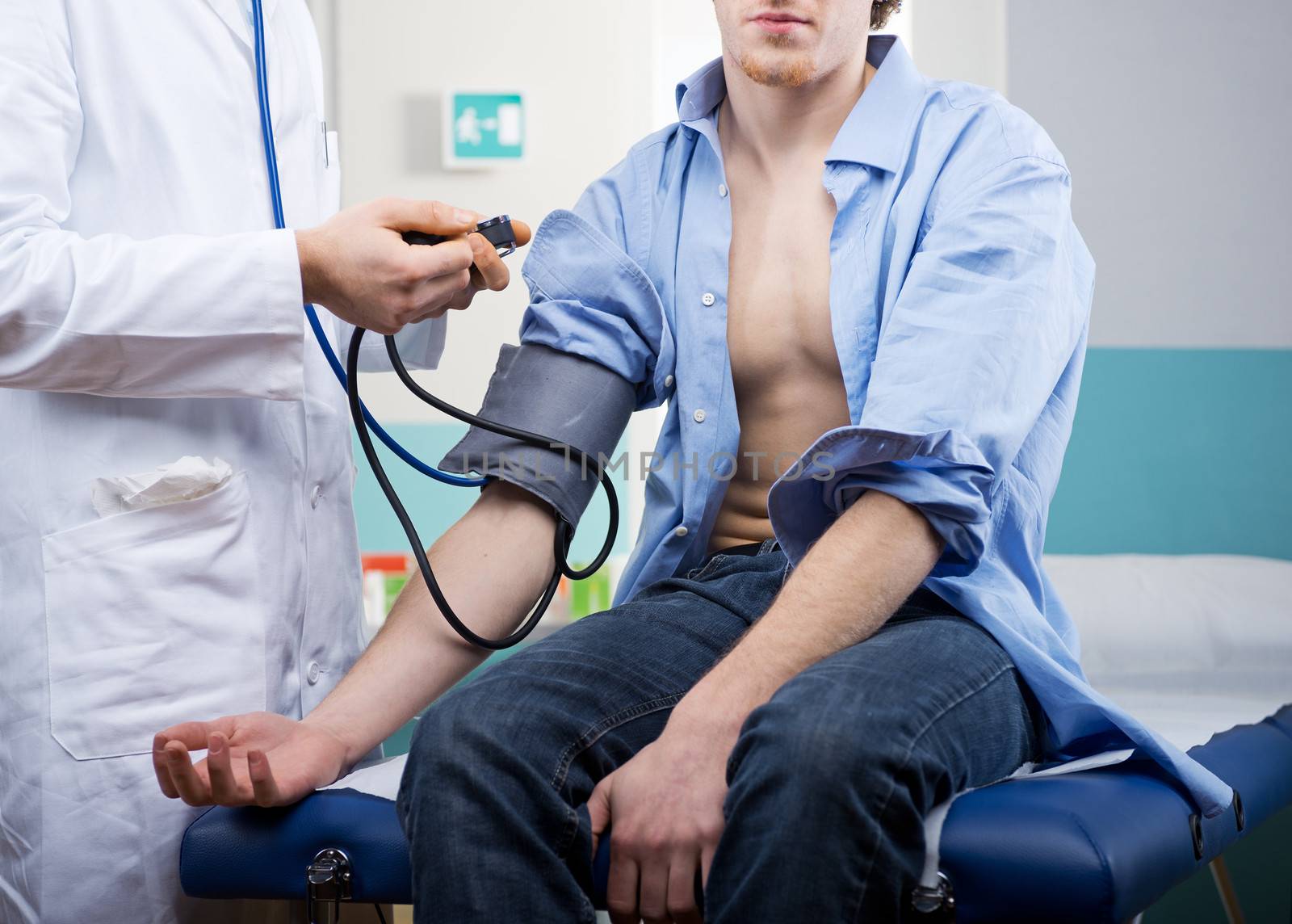 Doctor measuring blood pressure with specific medical equipment.