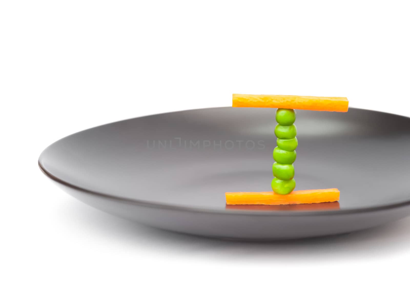 balanced diet food concept using peas and carrots on a plate