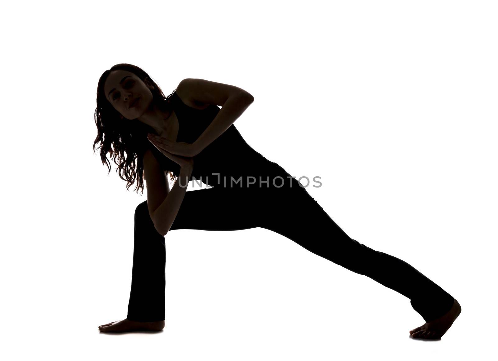 Silhouette of a woman doing Twisted Lunge in Yoga by snowwhite