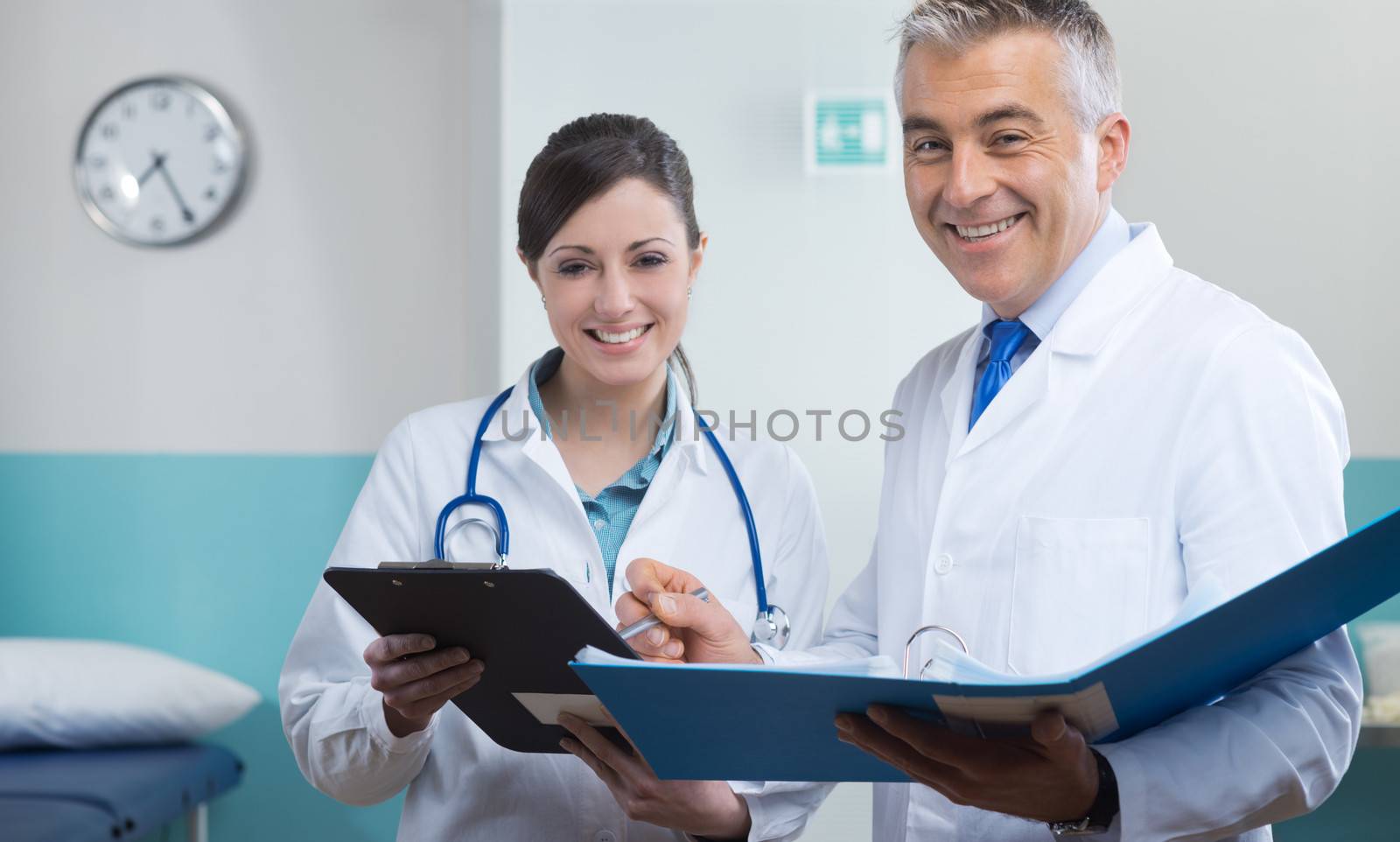 Young assistant and doctor checking medical records and documents.