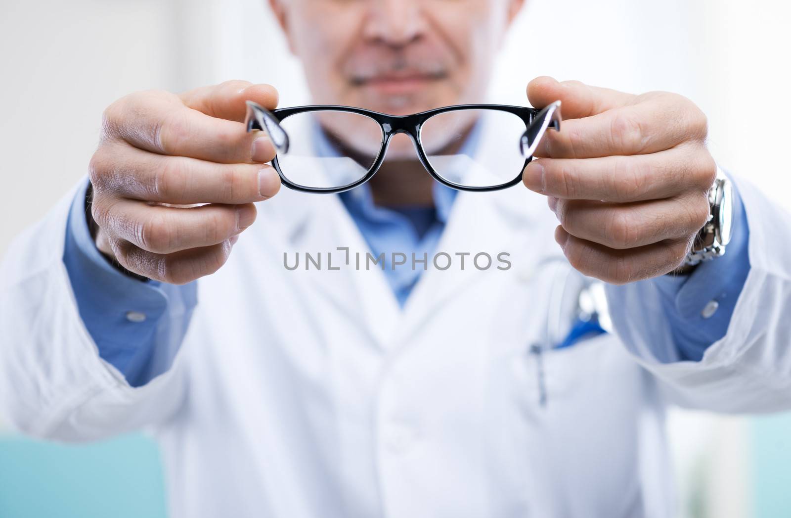 Oculist giving a pair of glasses during a visit.