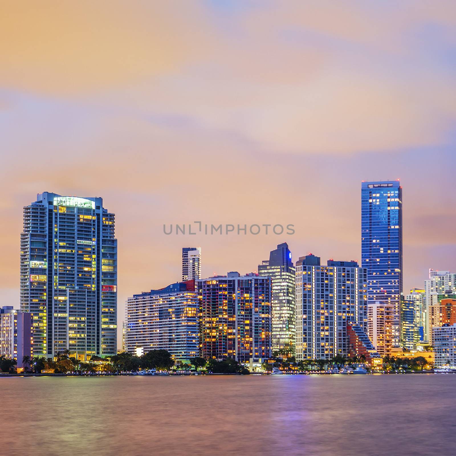 Miami Florida, summer sunset with colorful illuminated business and residential buildings and bridge on Biscayne Bay 