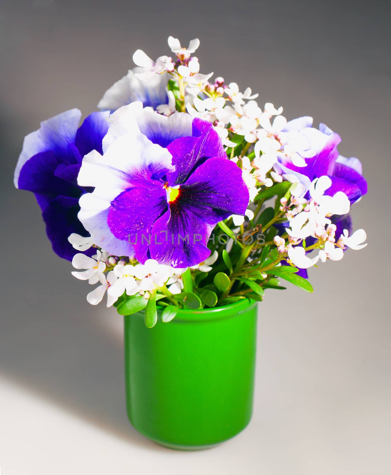 Bunch of flowers in a vase over grey background