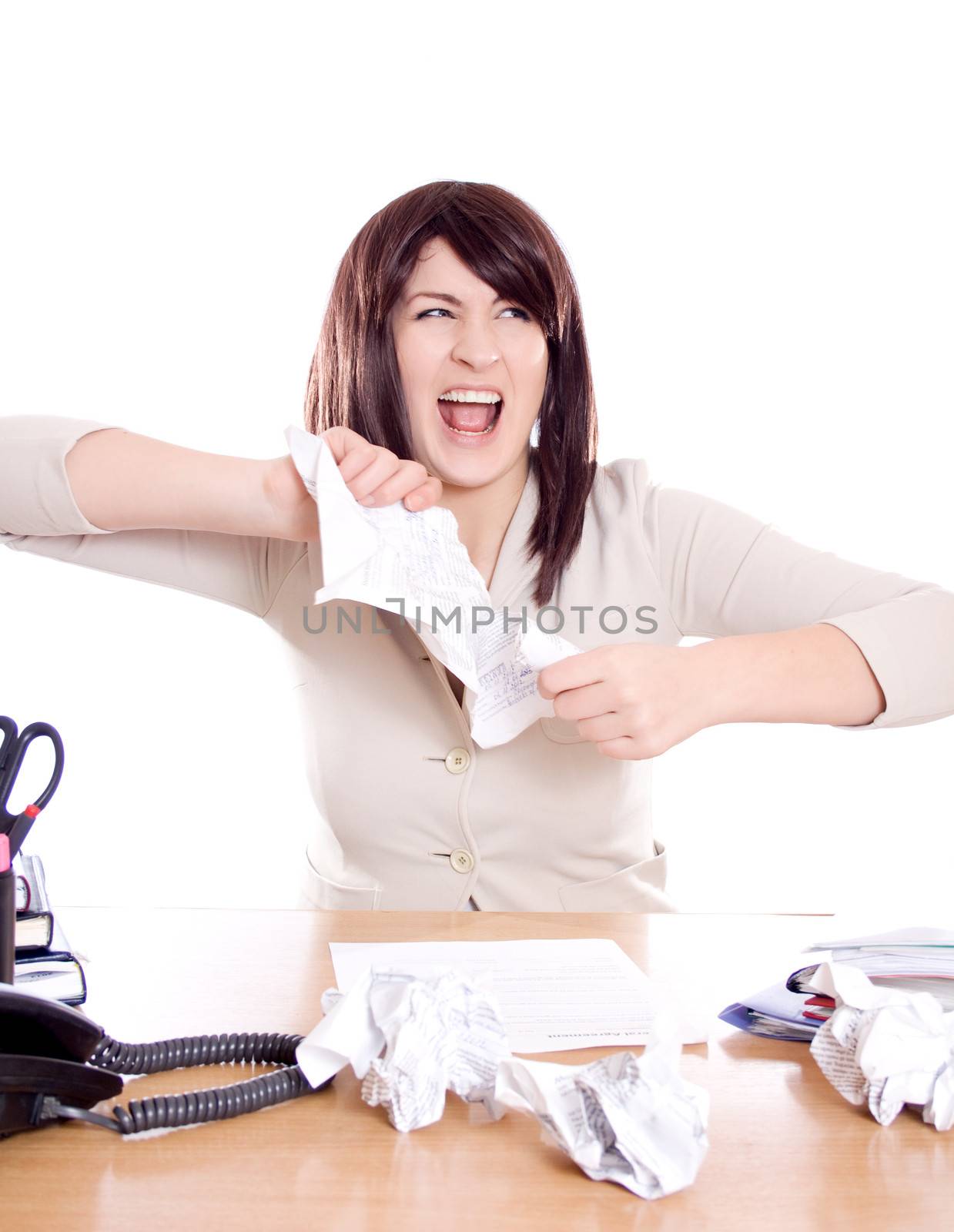 Young business woman in anger tears the paper