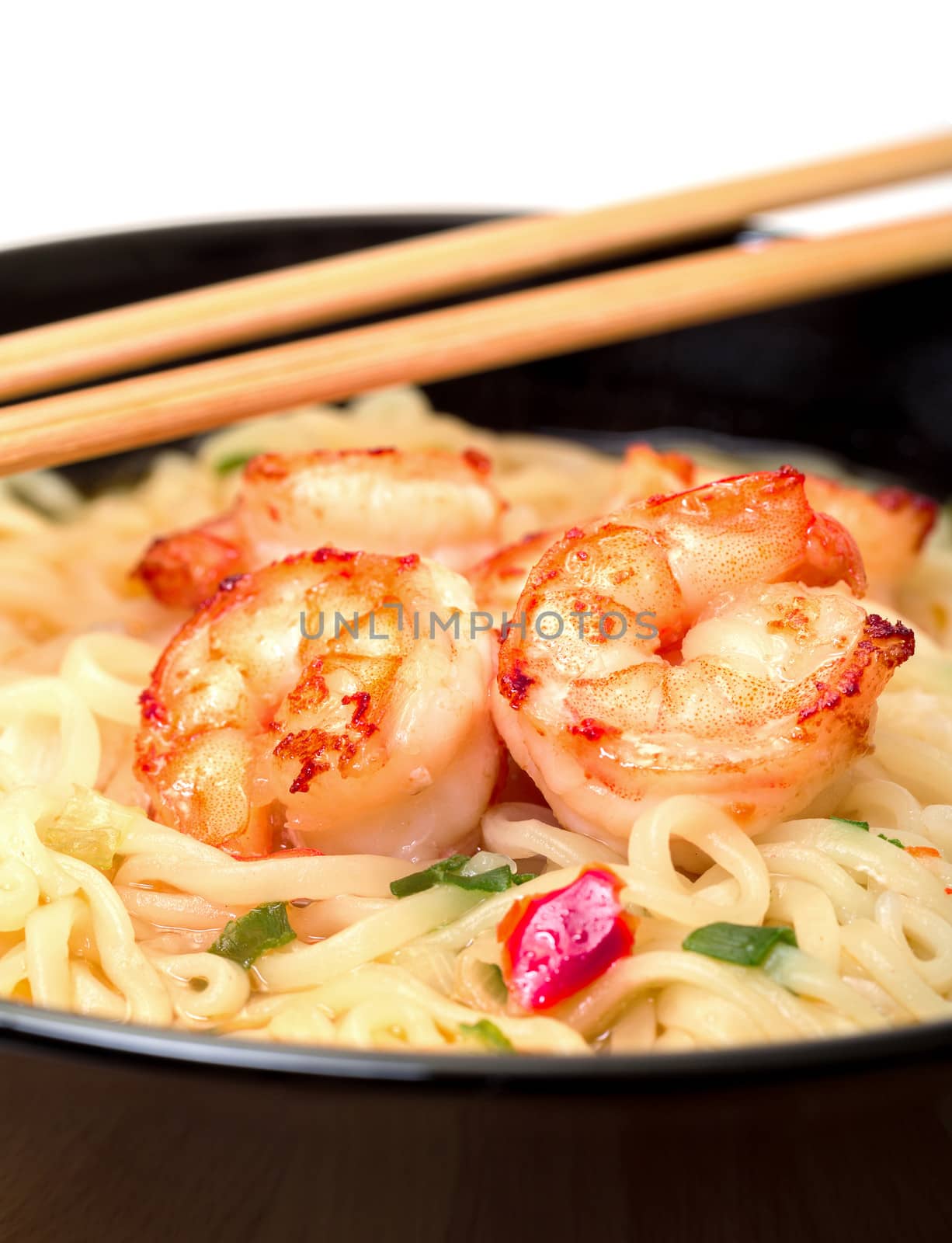 Shrimp and noodle soup bowl with chopsticks closeup