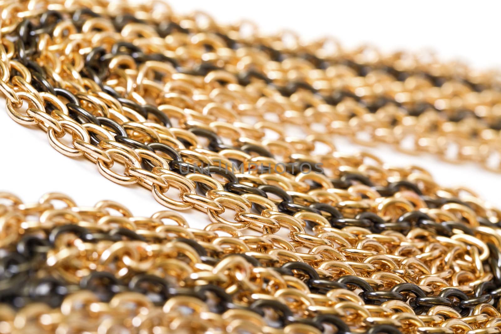 Golden and black chains, closeup on the white background