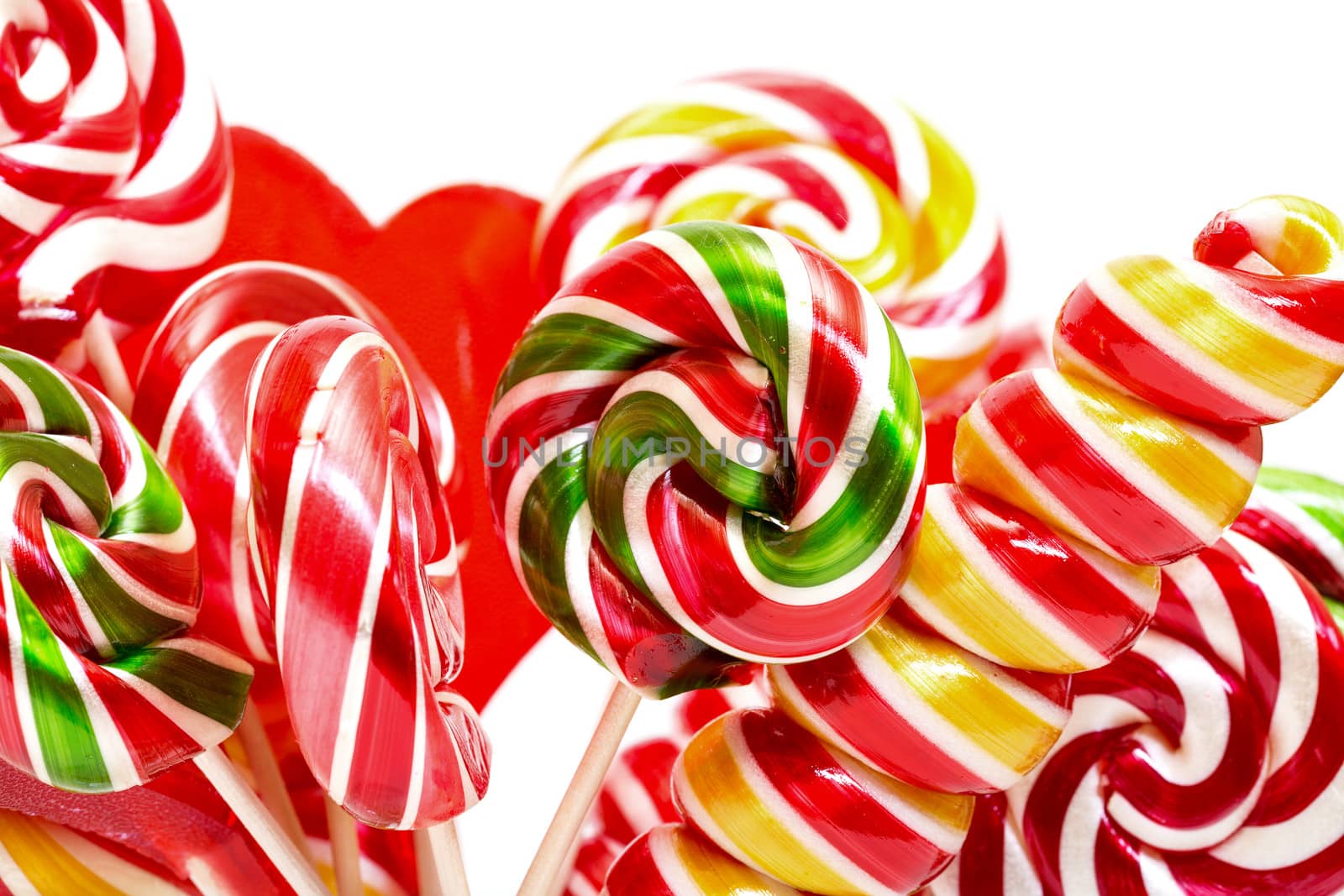 Multi-colored lollypop, closeup on a white background