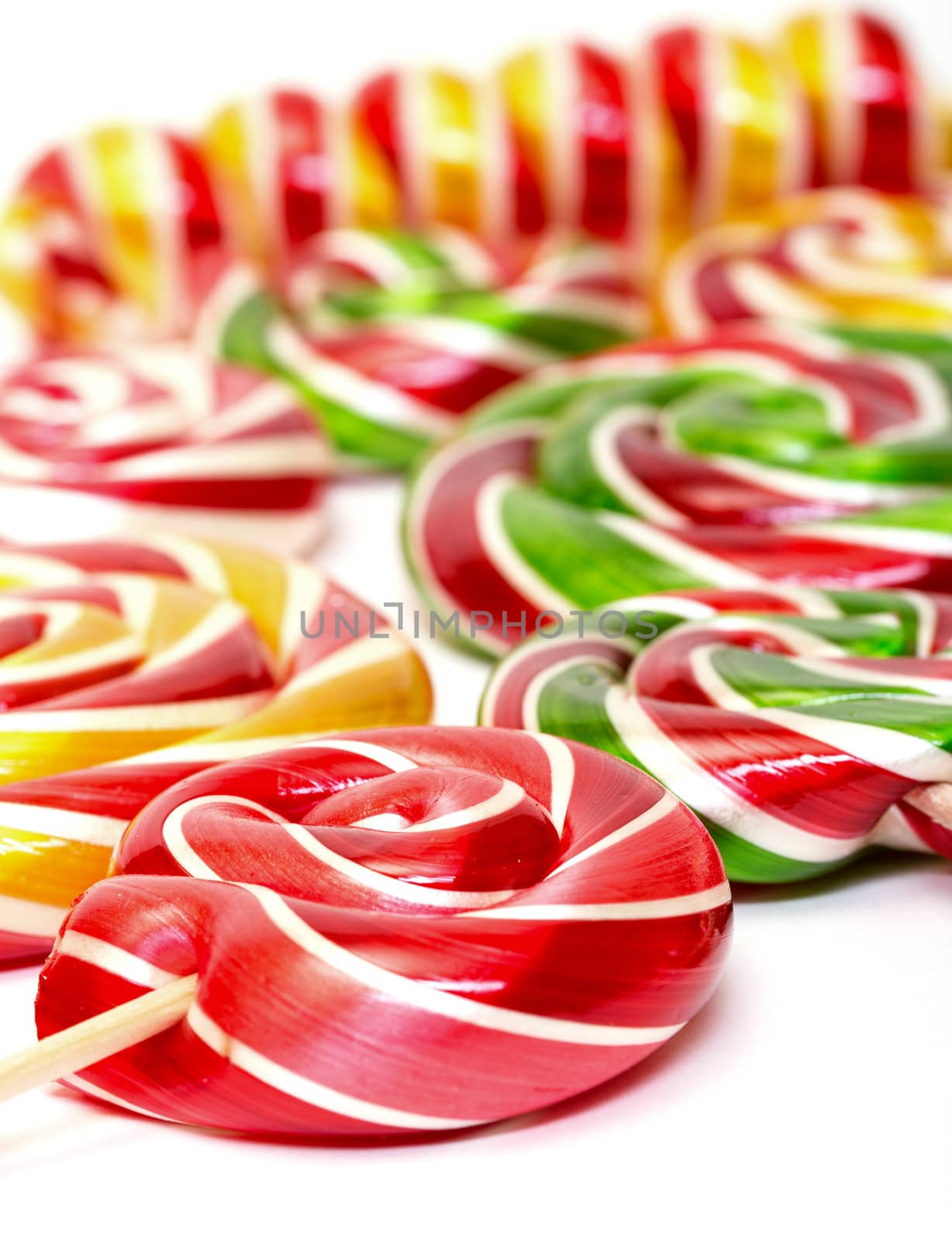 Multi-colored lollypop, closeup on a white background