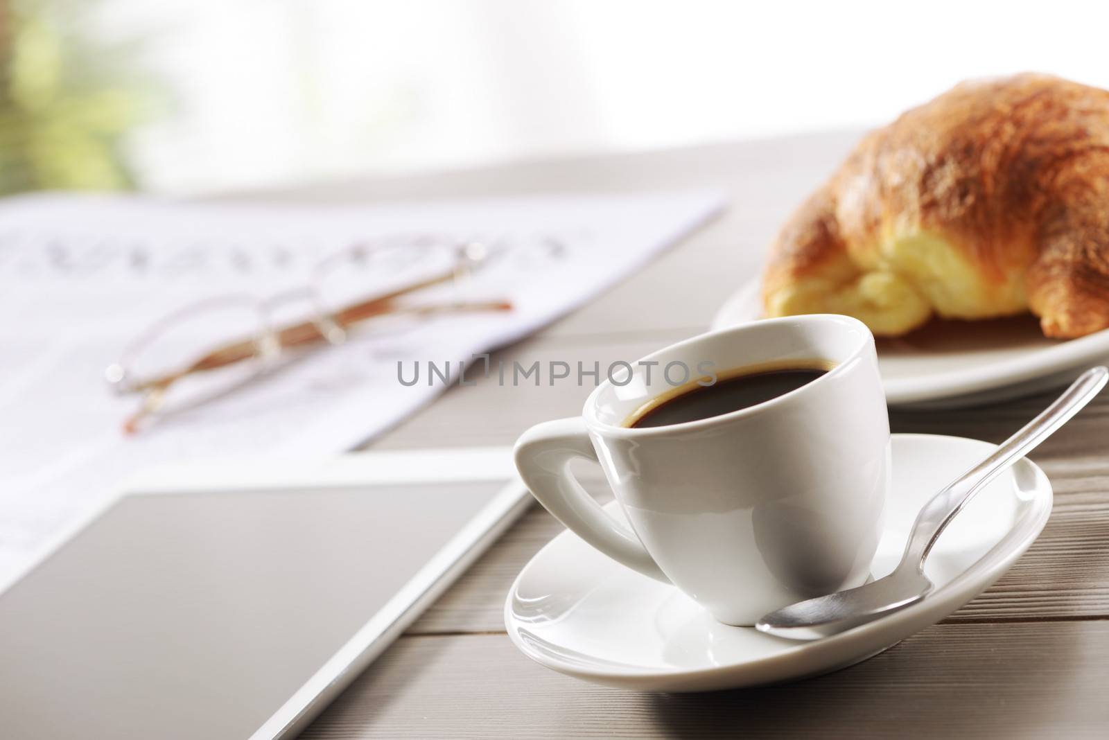 Business Office scene, digital tablet and newspaper with coffee 