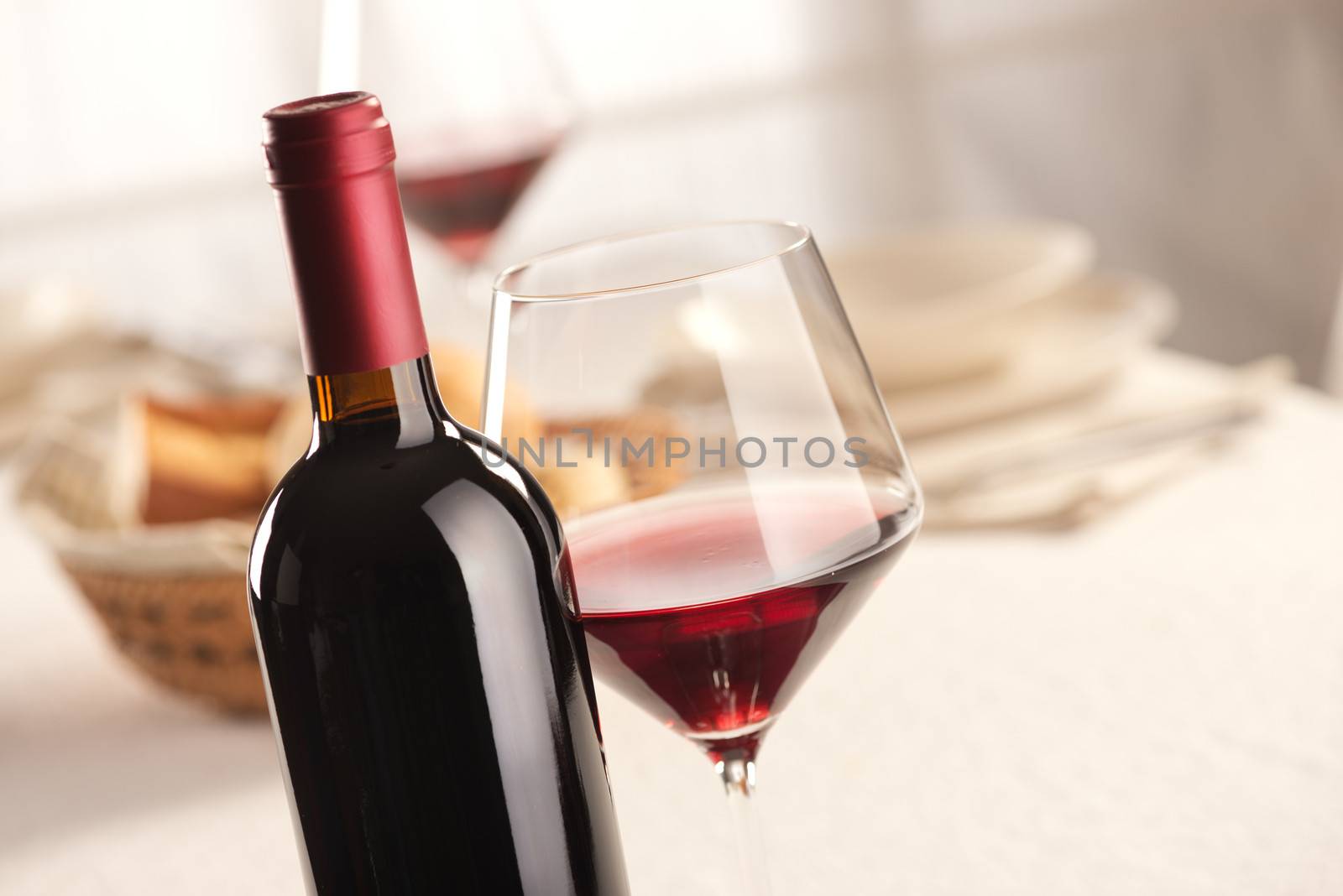 Red wine glass and bottle still life at restaurant.