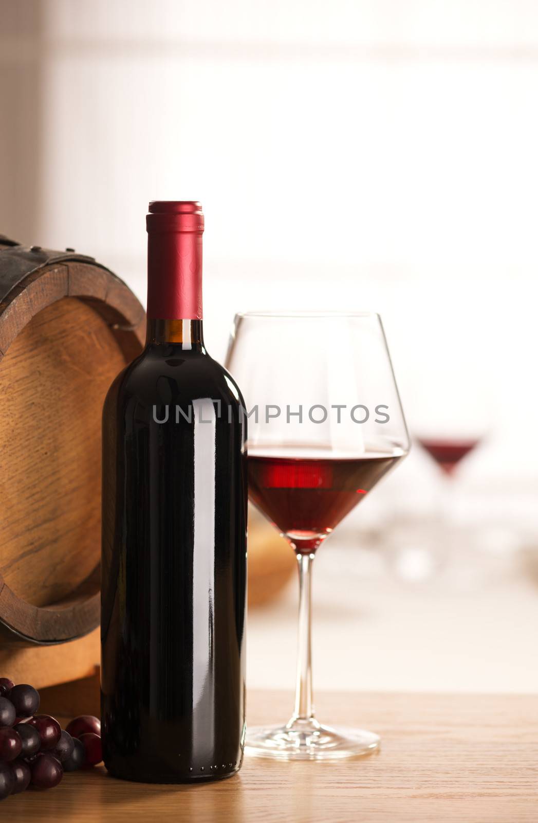 Red wine glass and bottle still life at restaurant.