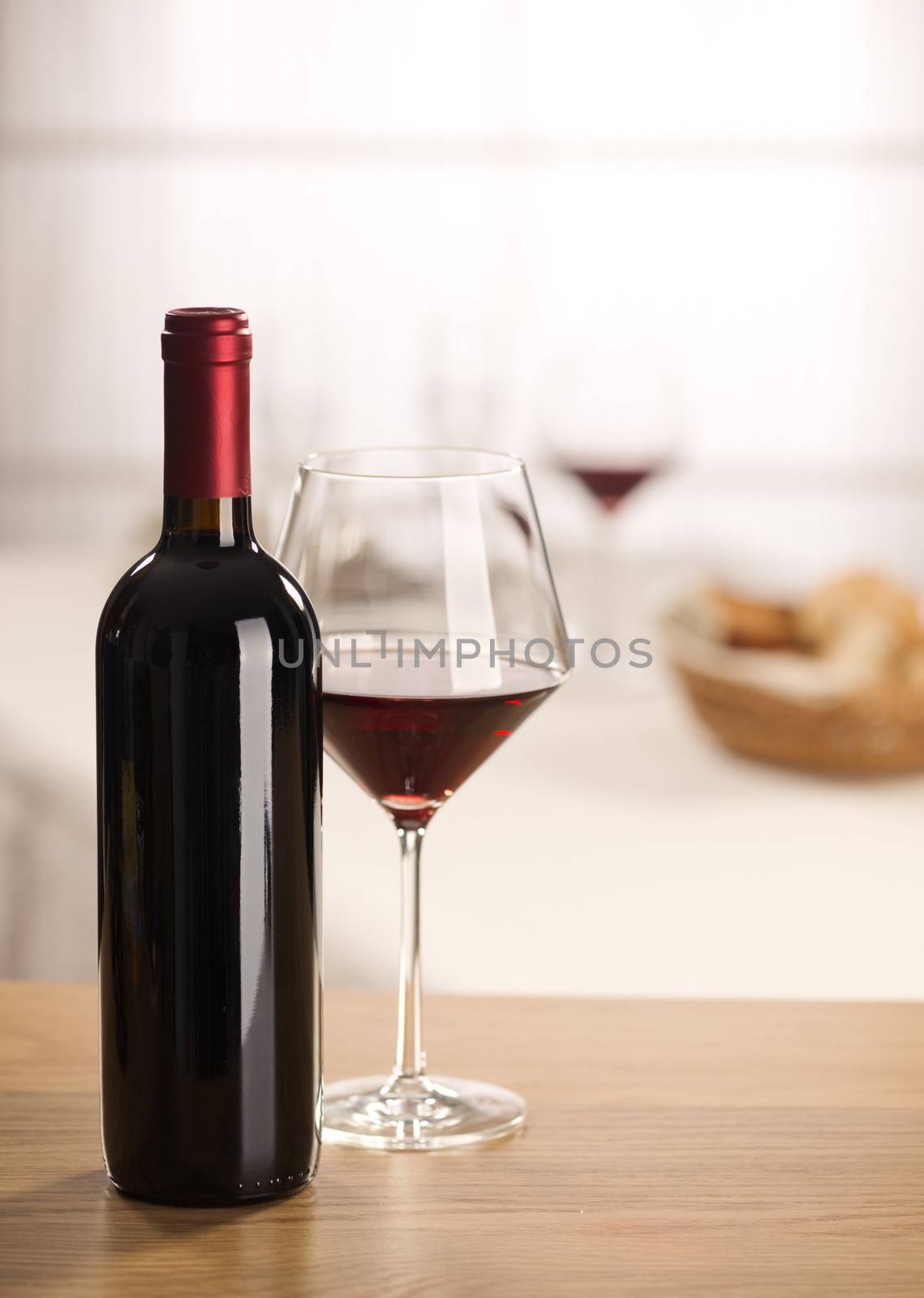 Red wine glass and bottle still life at restaurant.