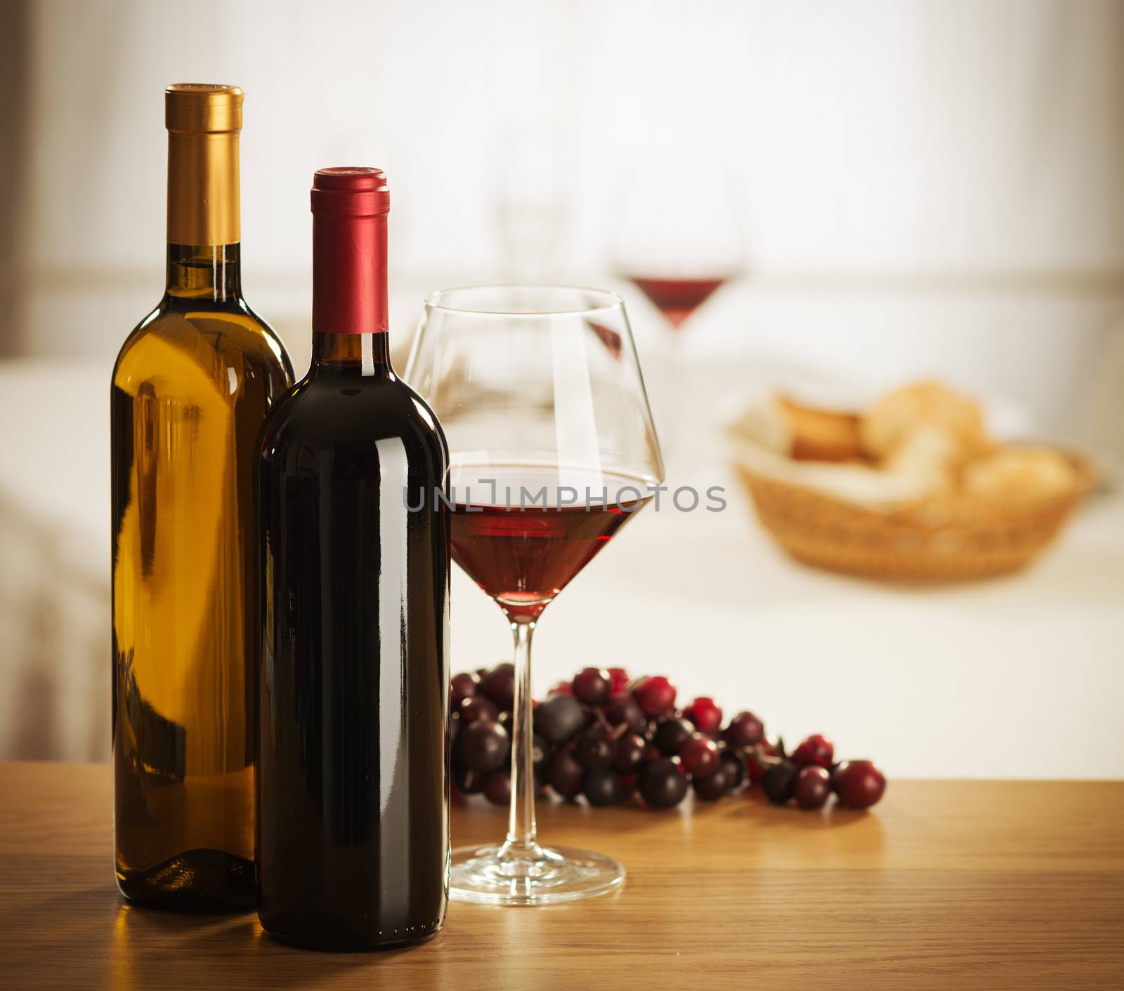 Red wine glass and bottle still life at restaurant.