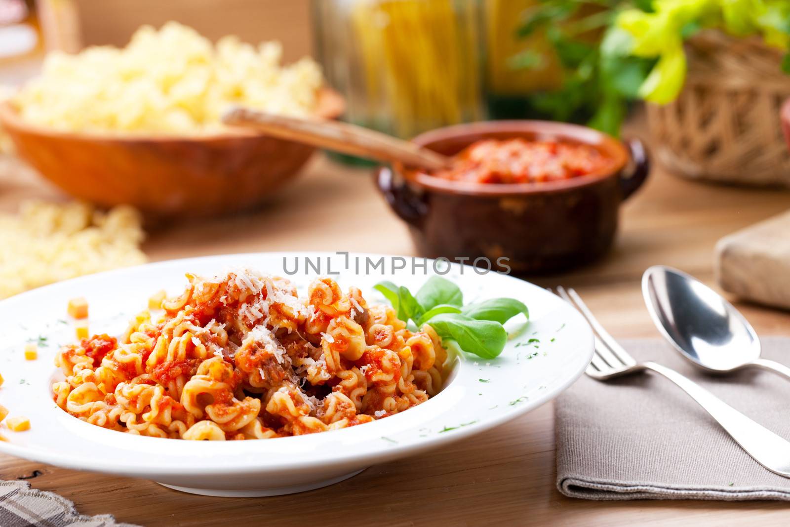 Italian food: pasta with tomato sauce and parmesan cheese.