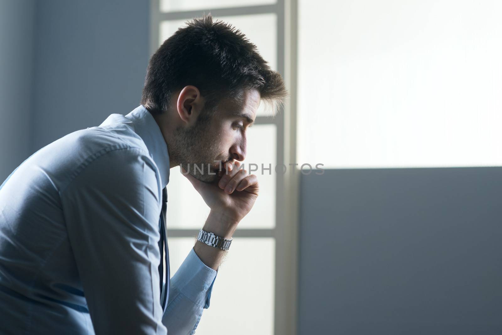 Tired pensive businessman by stokkete