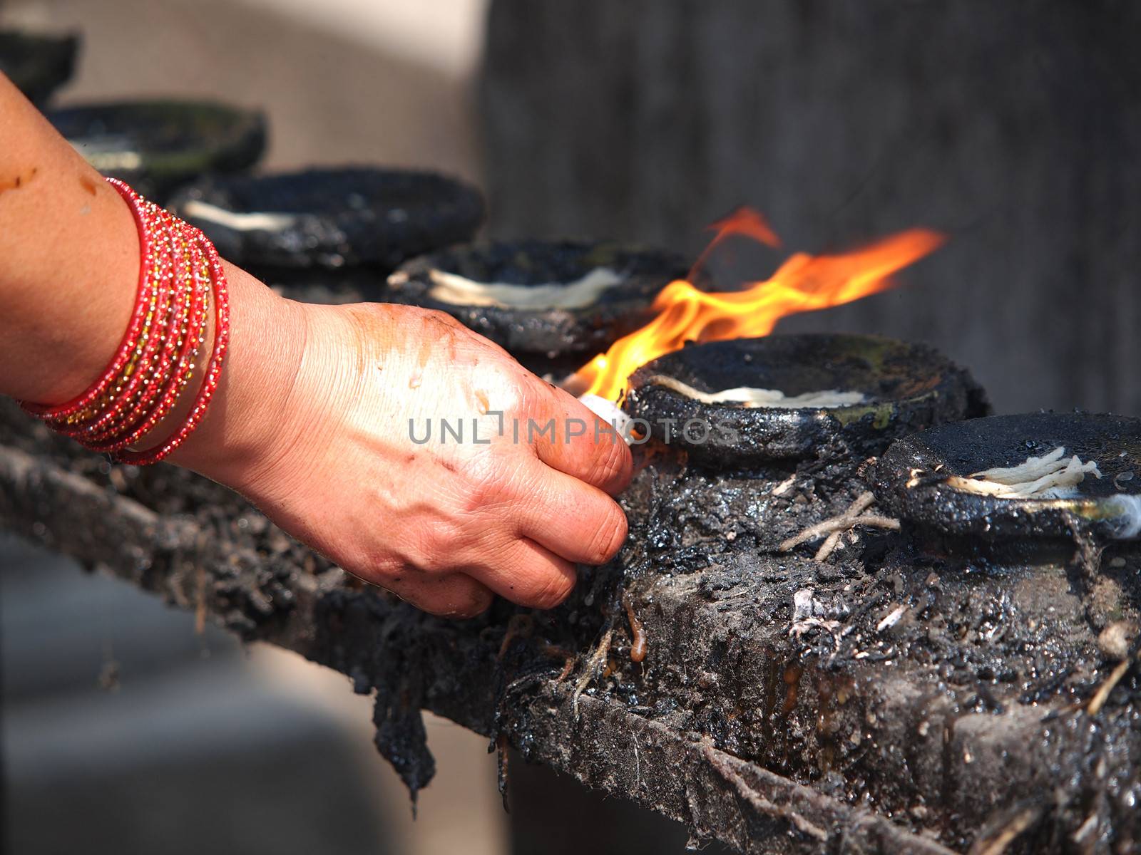 prayers hand burning candle in temple        