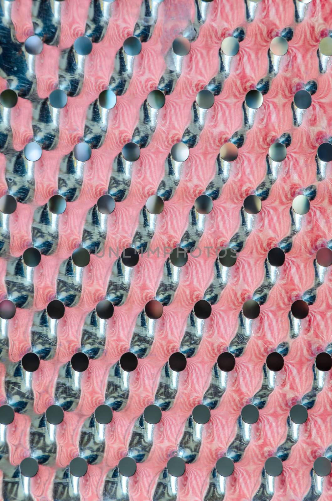 Detail macro view of kitchen grater equipment with color reflections