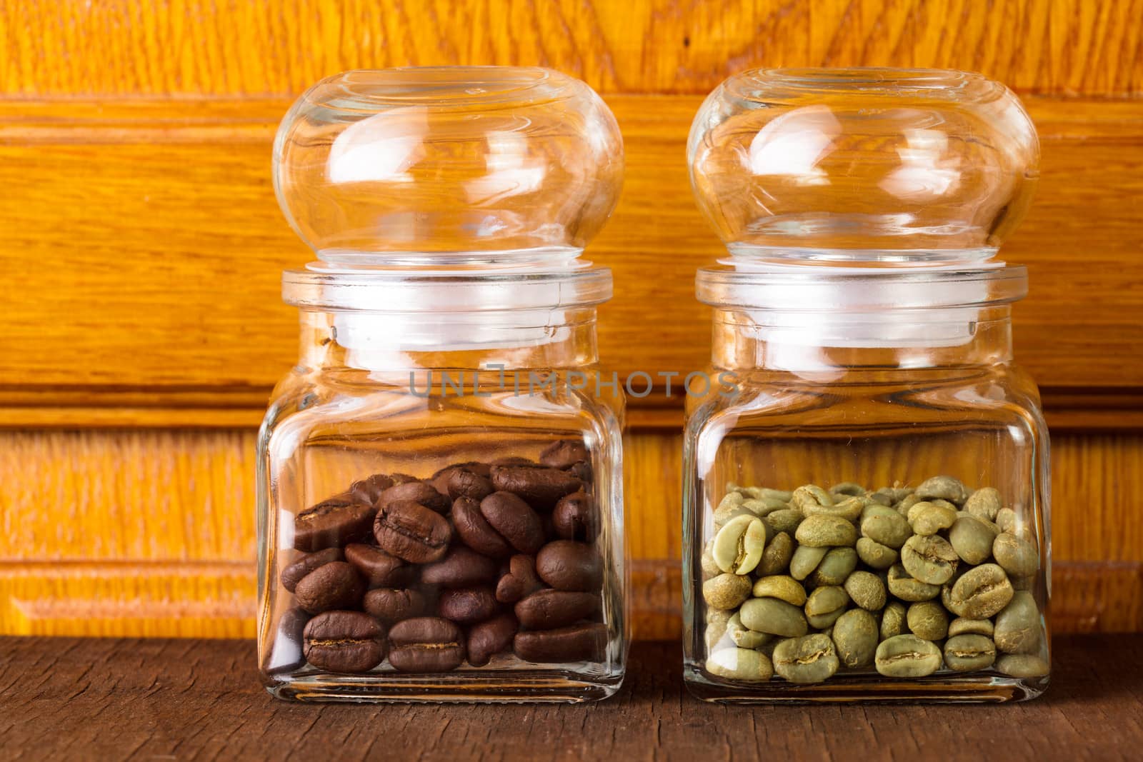 Black and green coffee beans in the glass bottles