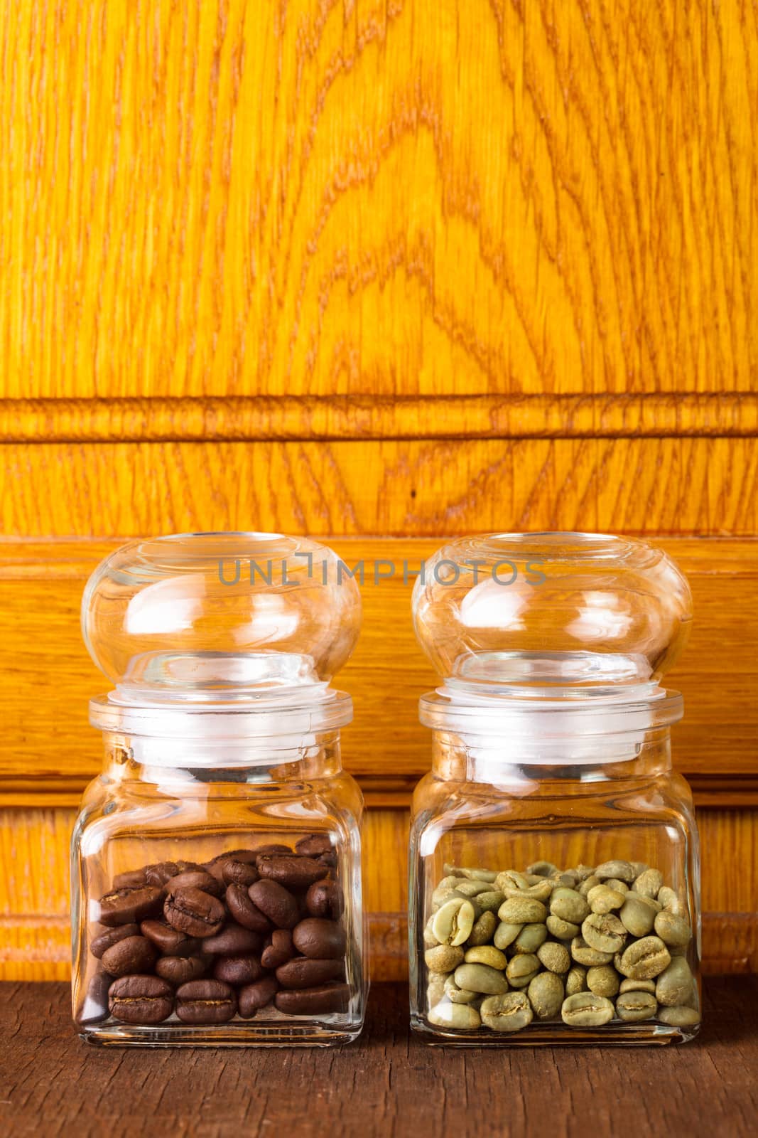 Black and green coffee beans in the glass bottles