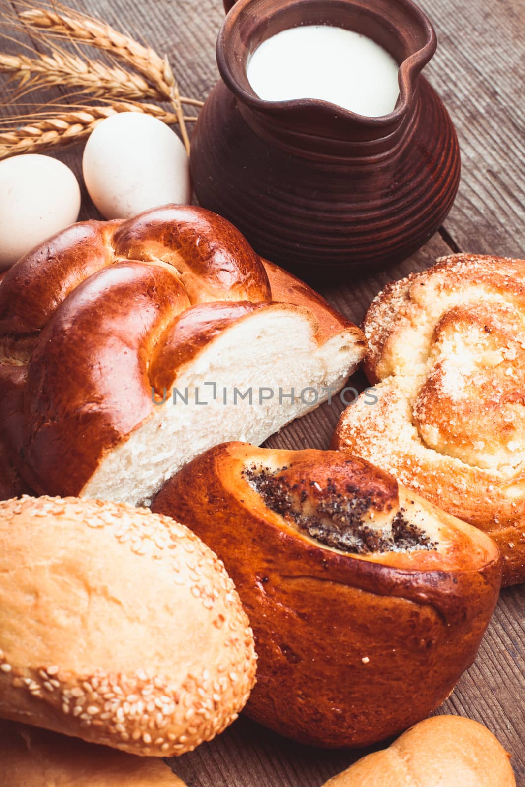 Types of homemade bread and jug with milk