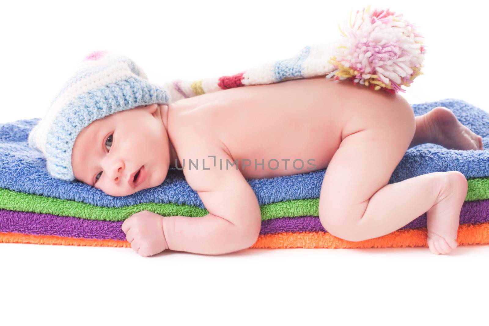 Baby on the color 
towels in crochet hat close up