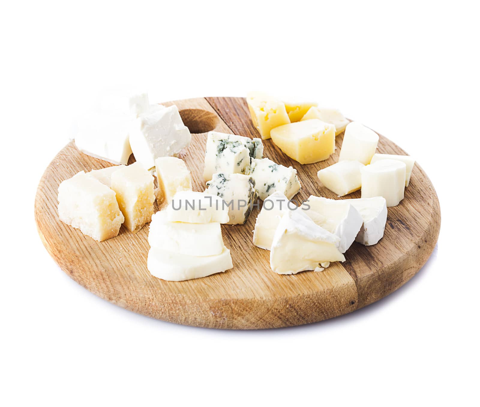 Board with pieces of various types of cheese on the board