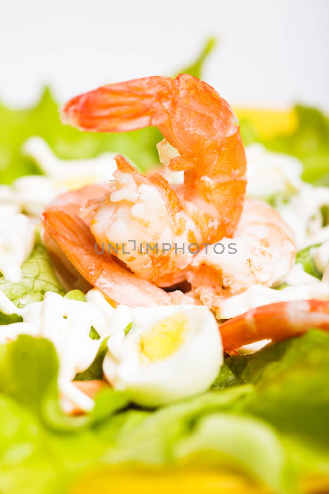 Salad with boiled shrimps, quail eggs and sauce