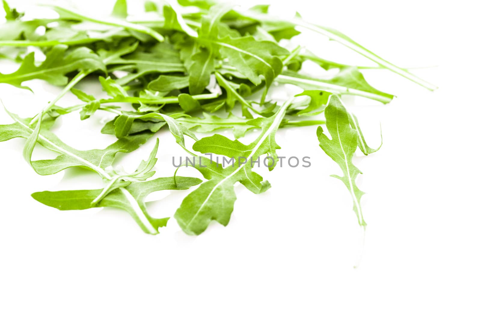 Fresh green arugula heap isolated on white