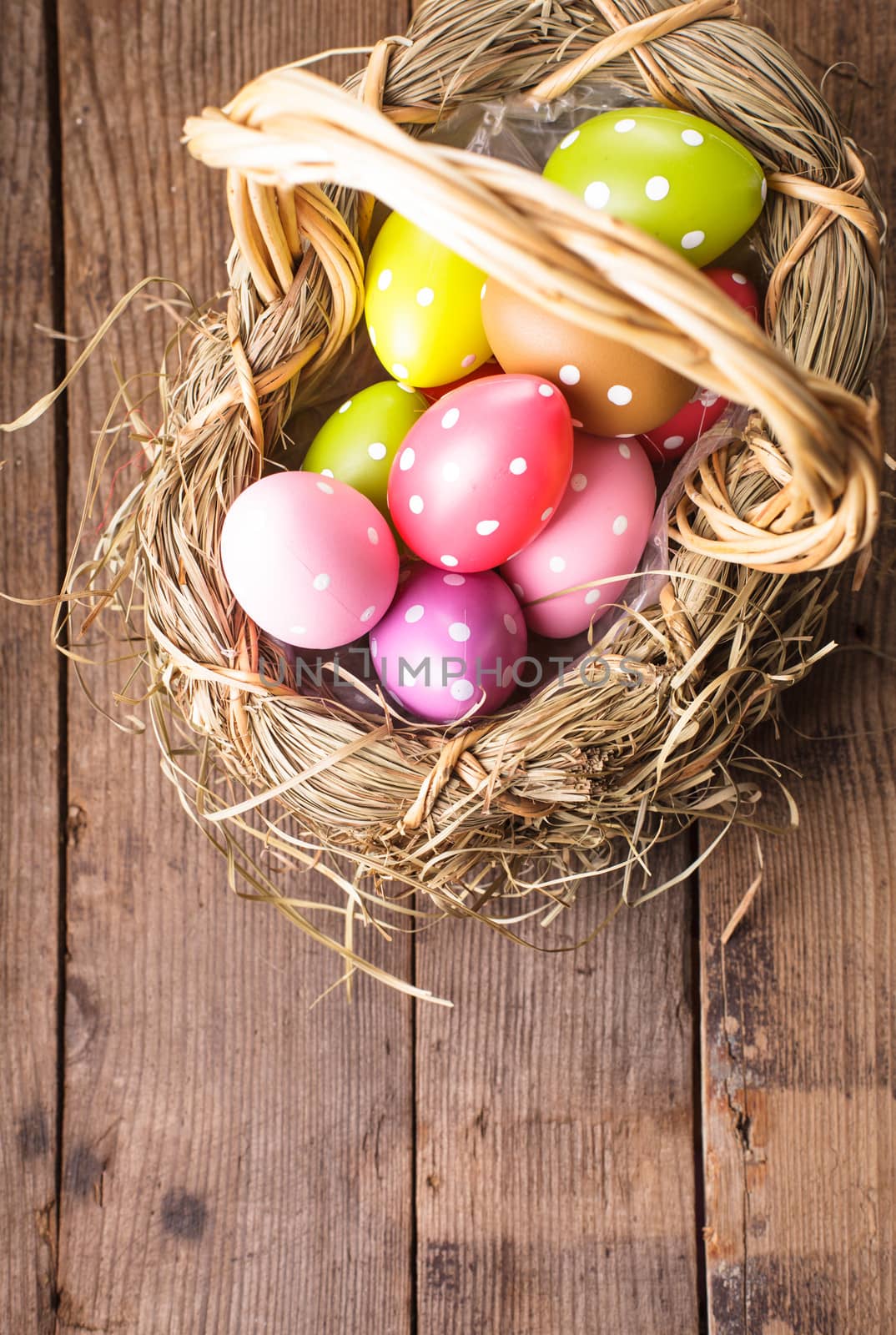 Colorful polka dot eggs in basket with copy space, Easter decorations