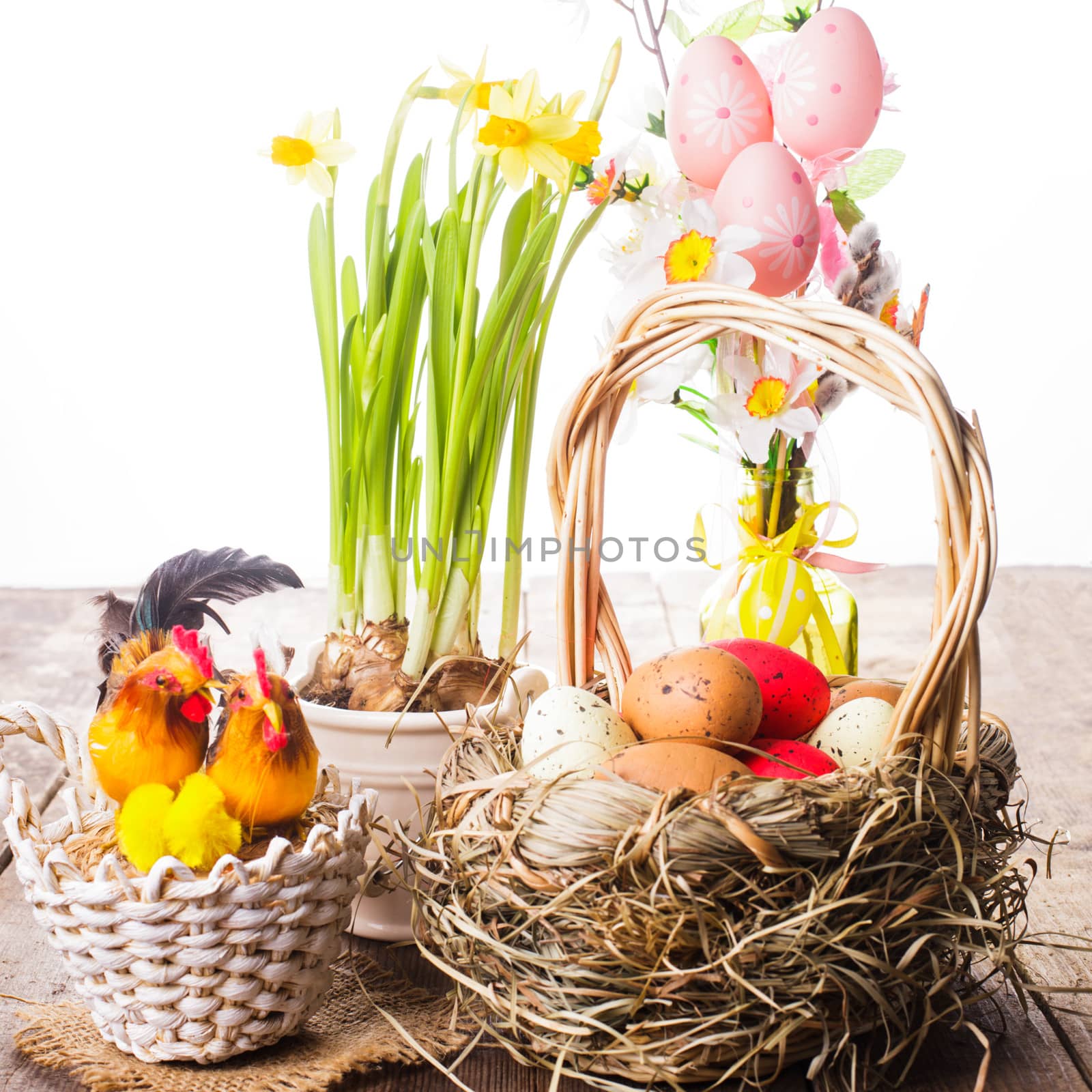 Pink and yellow eggs in basket, Easter decorations on white background