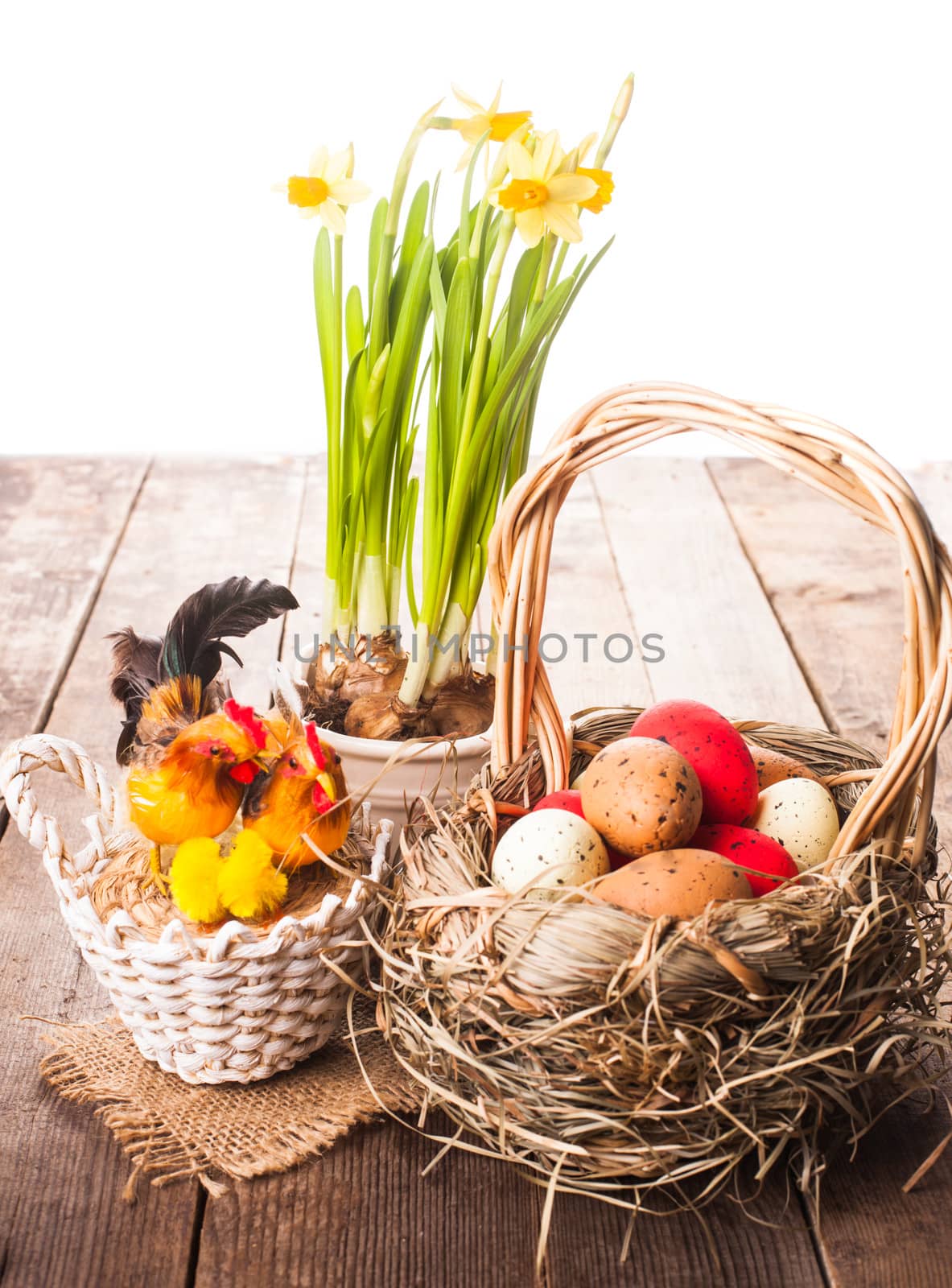 Pink and yellow eggs in basket, Easter decorations on white background