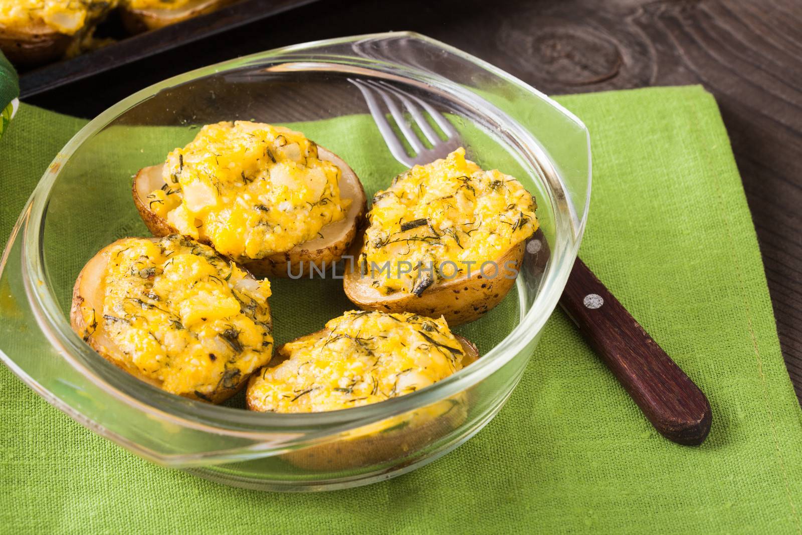 Stuffed baked potato with eggs, cheese and spices