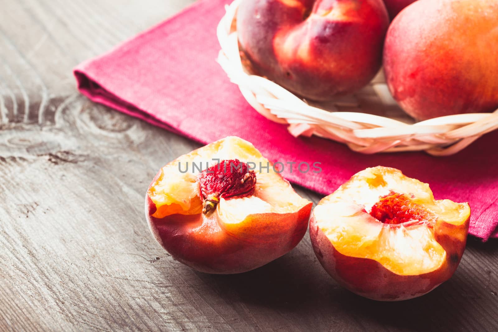 Peaches in the wooven bowl on the table