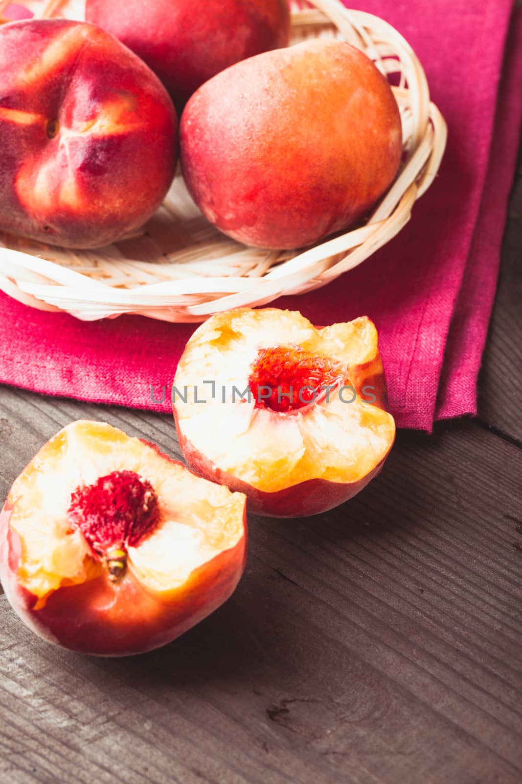 Peaches in the wooven bowl on the table