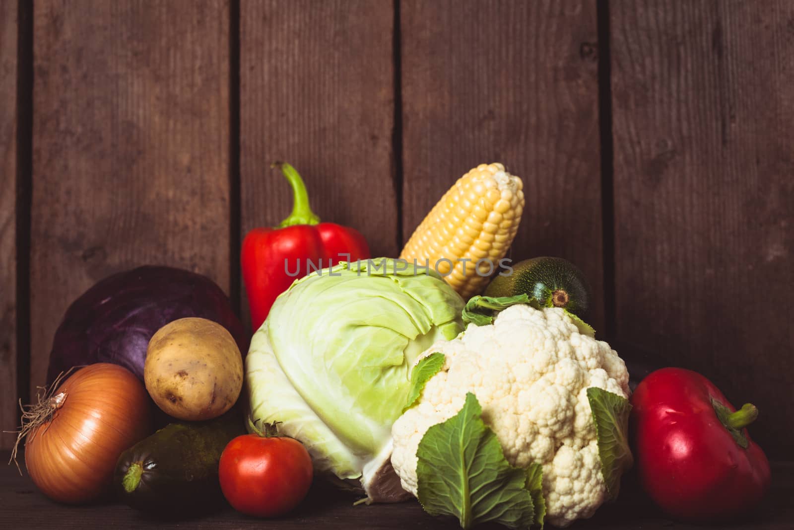 Still life of vegetables on the wood background closeup