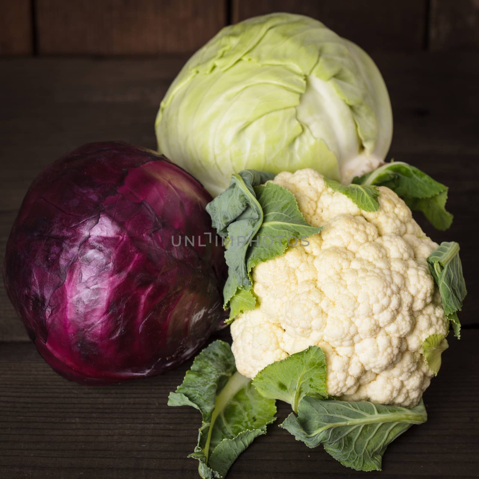 Cabbage types on the wooden table close up