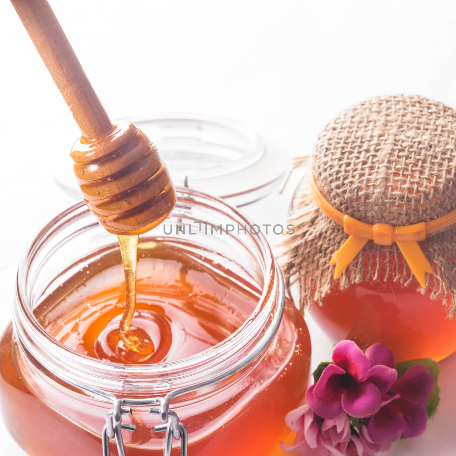 Honey drip and jar on white backround