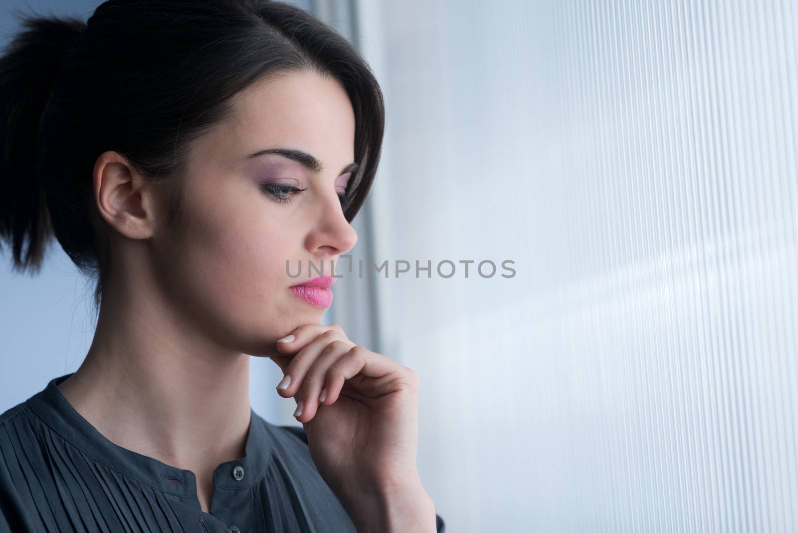 Young woman at window by stokkete