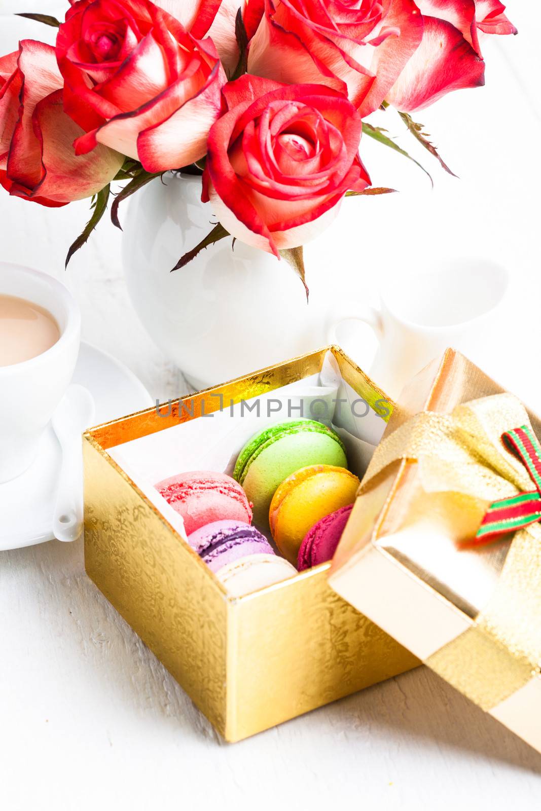 macaroon in gift box and roses in vase