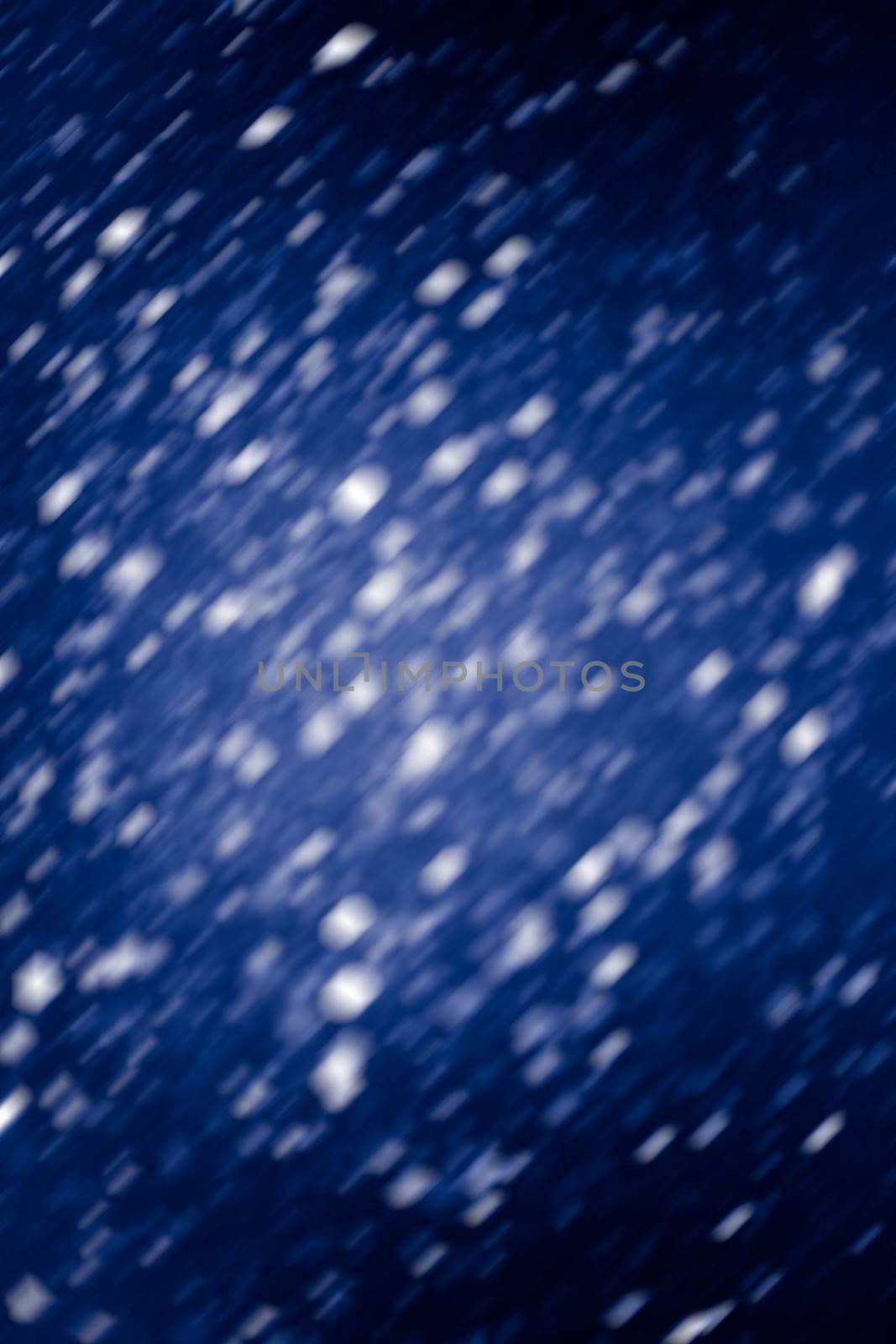 Falling snow background - snowflakes over night dark sky