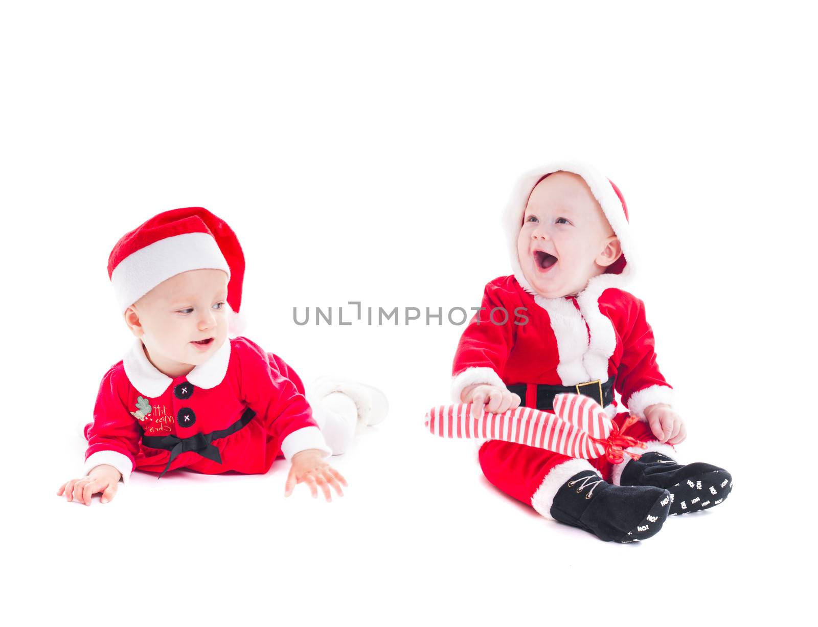 Adorable Santa babies - boy and girl isolated on white 