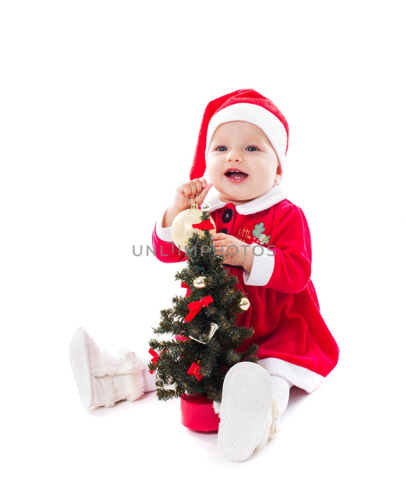 Santa girl wants to decorate fir tree isolated on white
