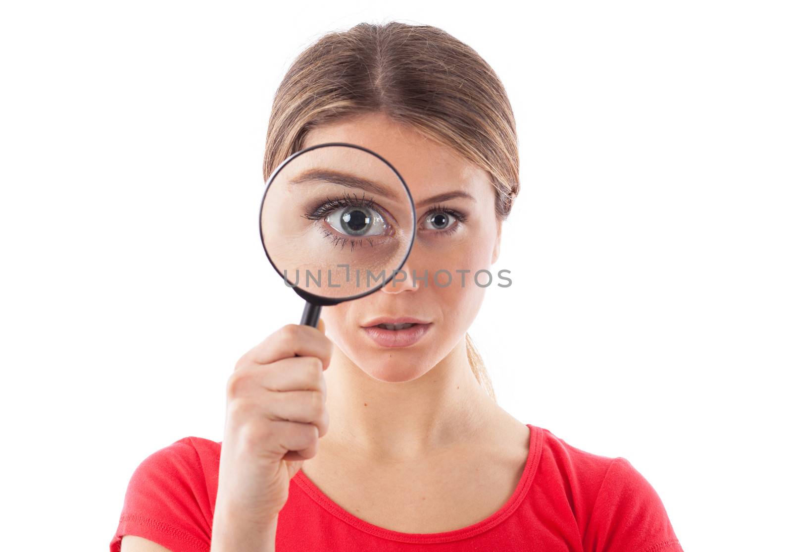 Beautiful woman looking through a magnifying glass, isolated on white