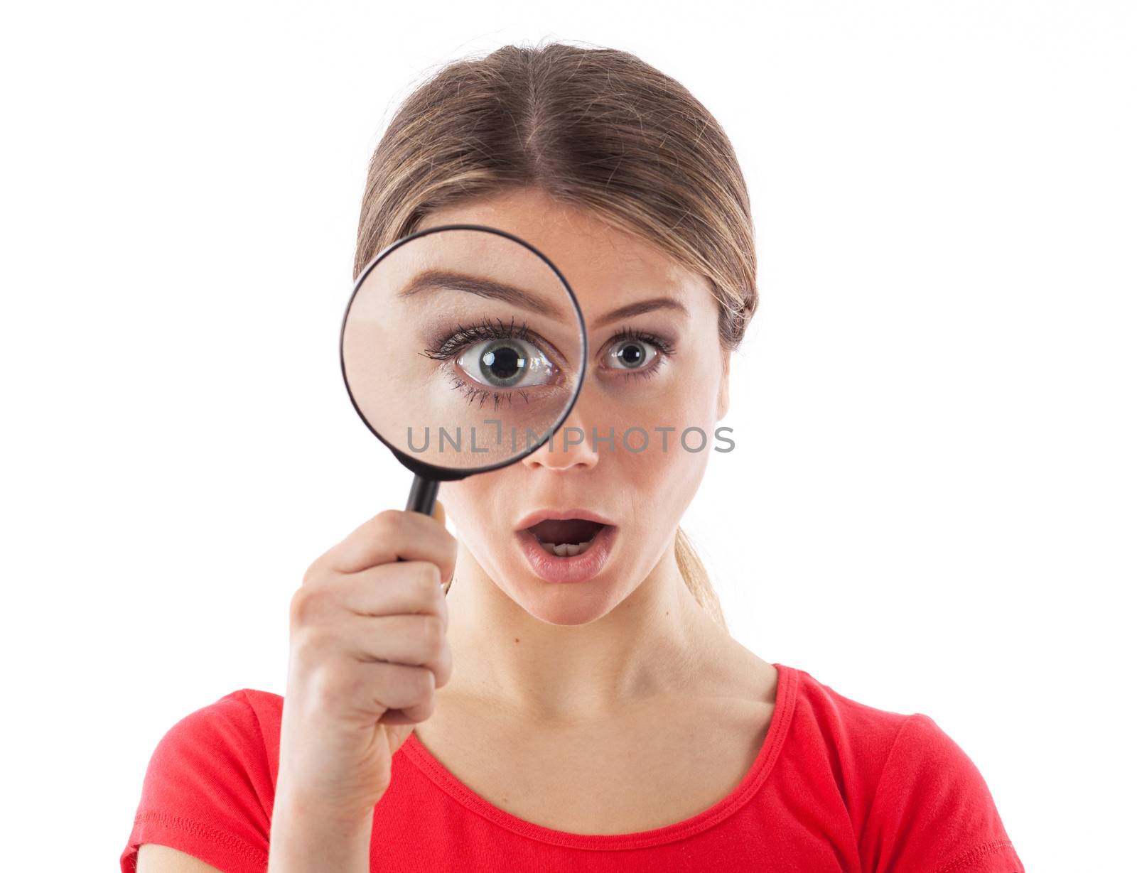 Woman looking through a magnifying glass and being surprised, isolated on white
