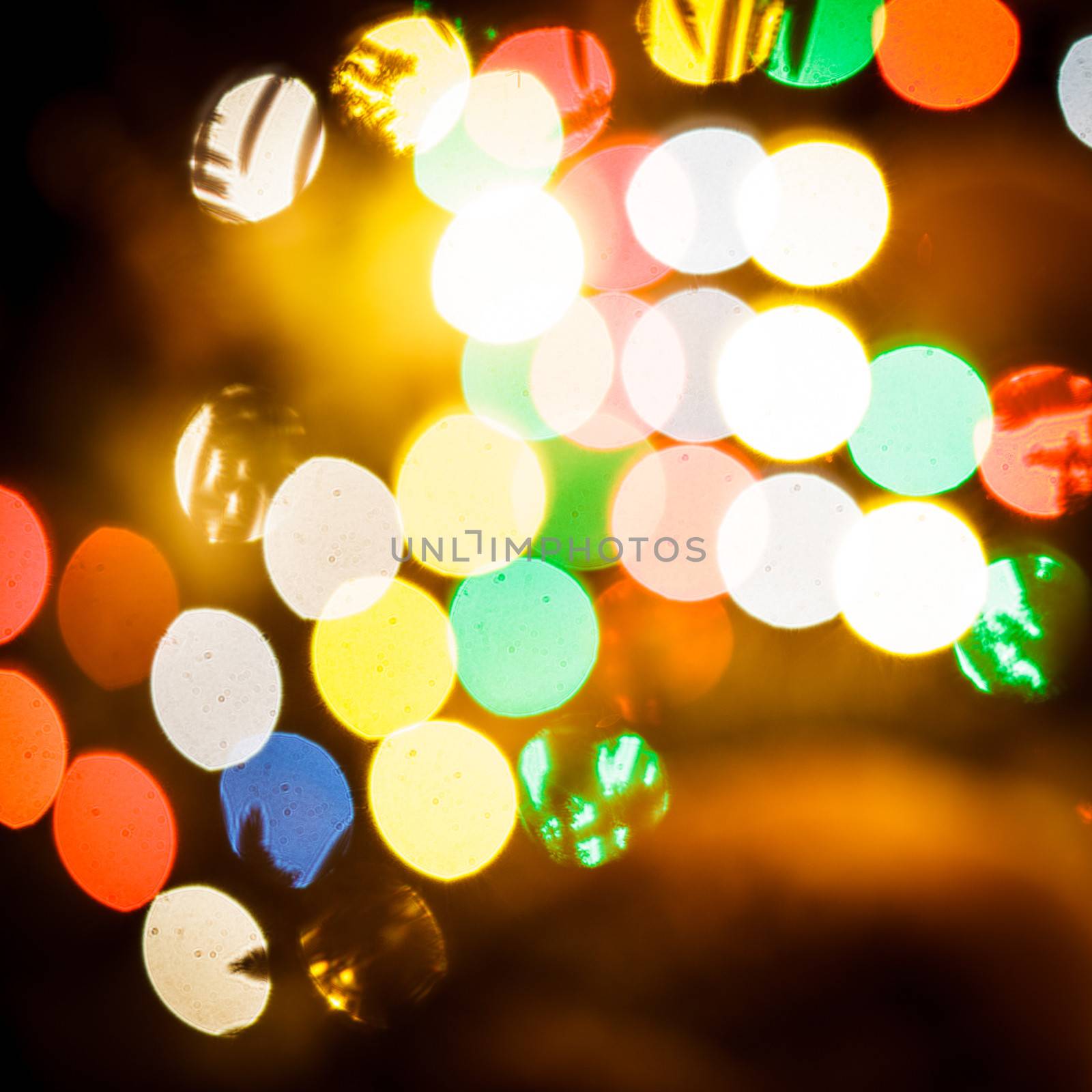 Abstract christmas fir-tree under the snow outdoors over the blurred lights