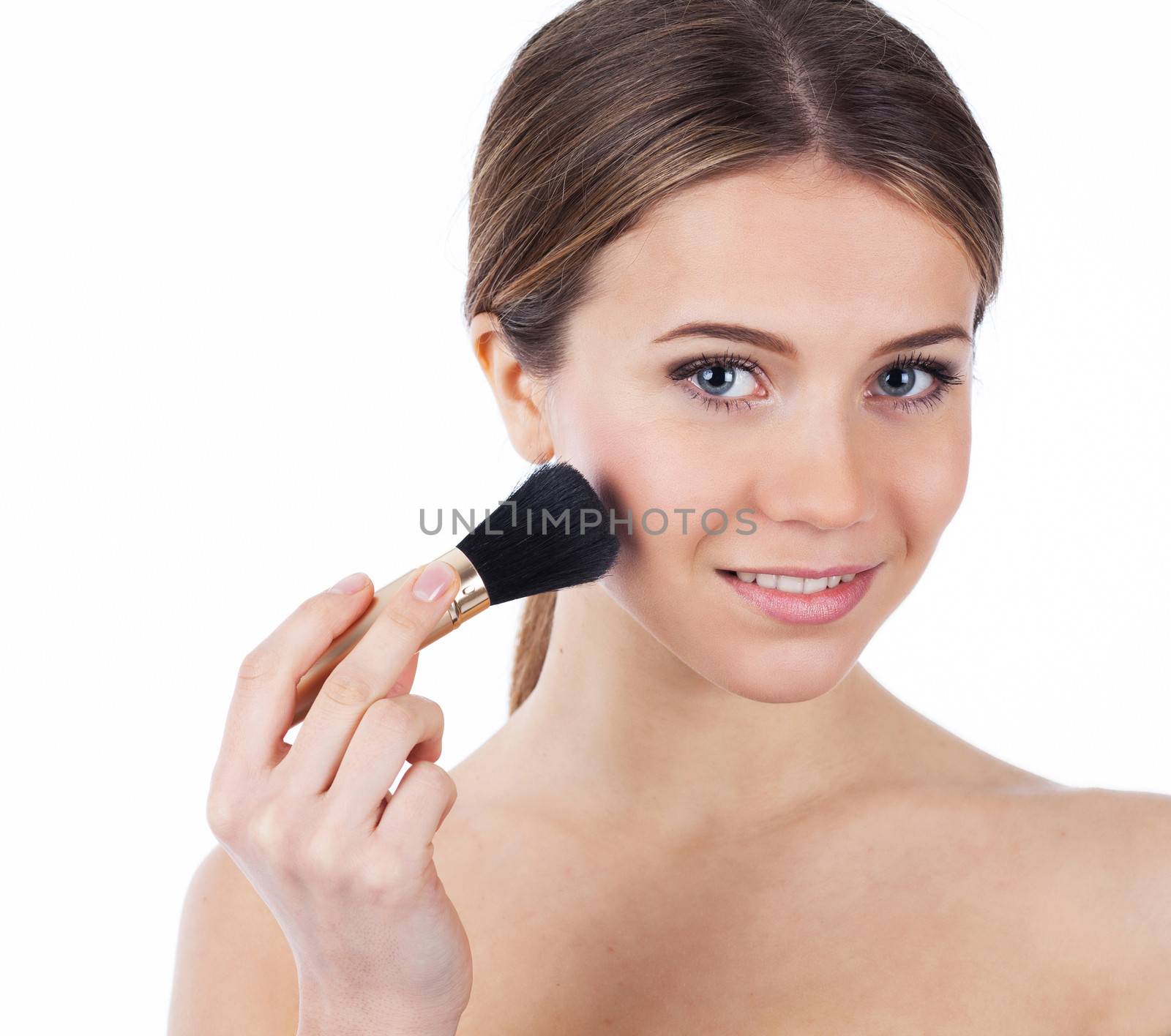 Close up portrait of a beautiful woman applying makeup, isolated on white