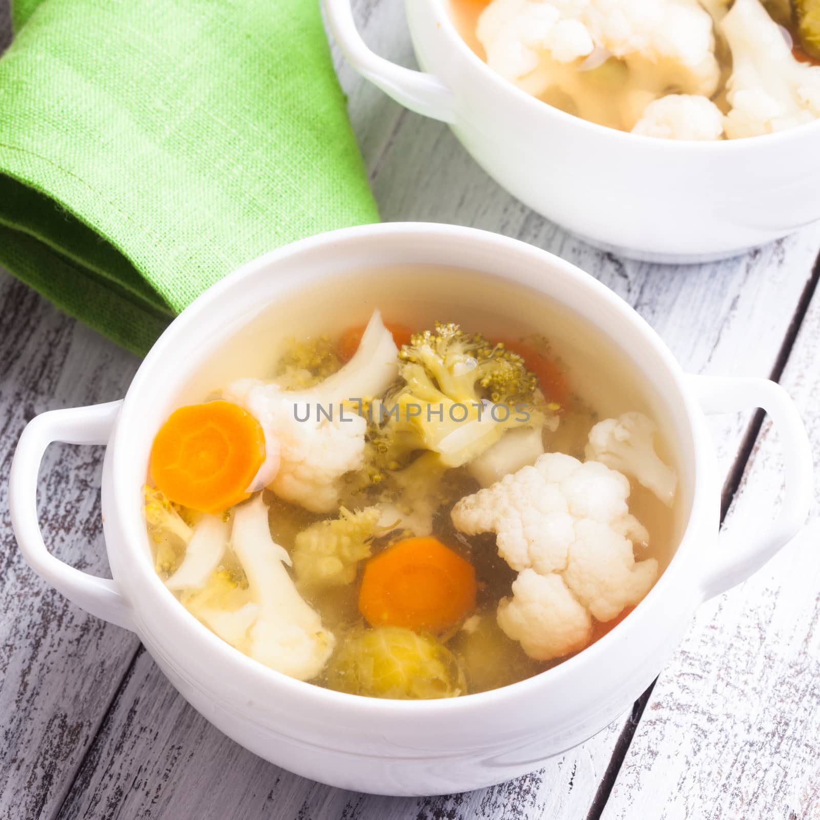 Vegetable soup in white bowl close up on the table