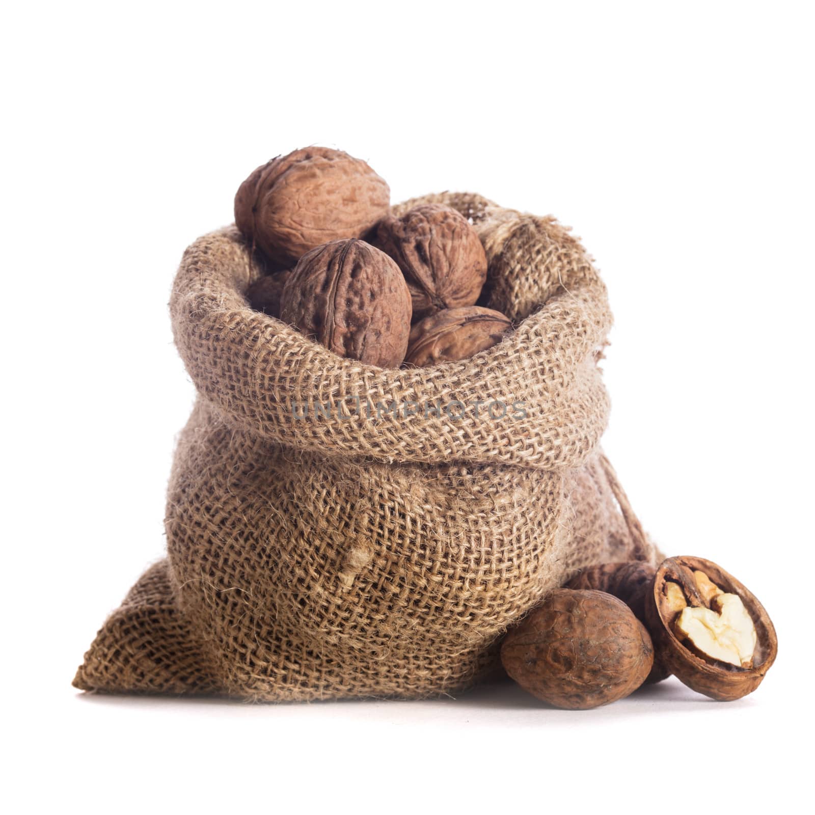 Walnuts in burlap bag isolated on white