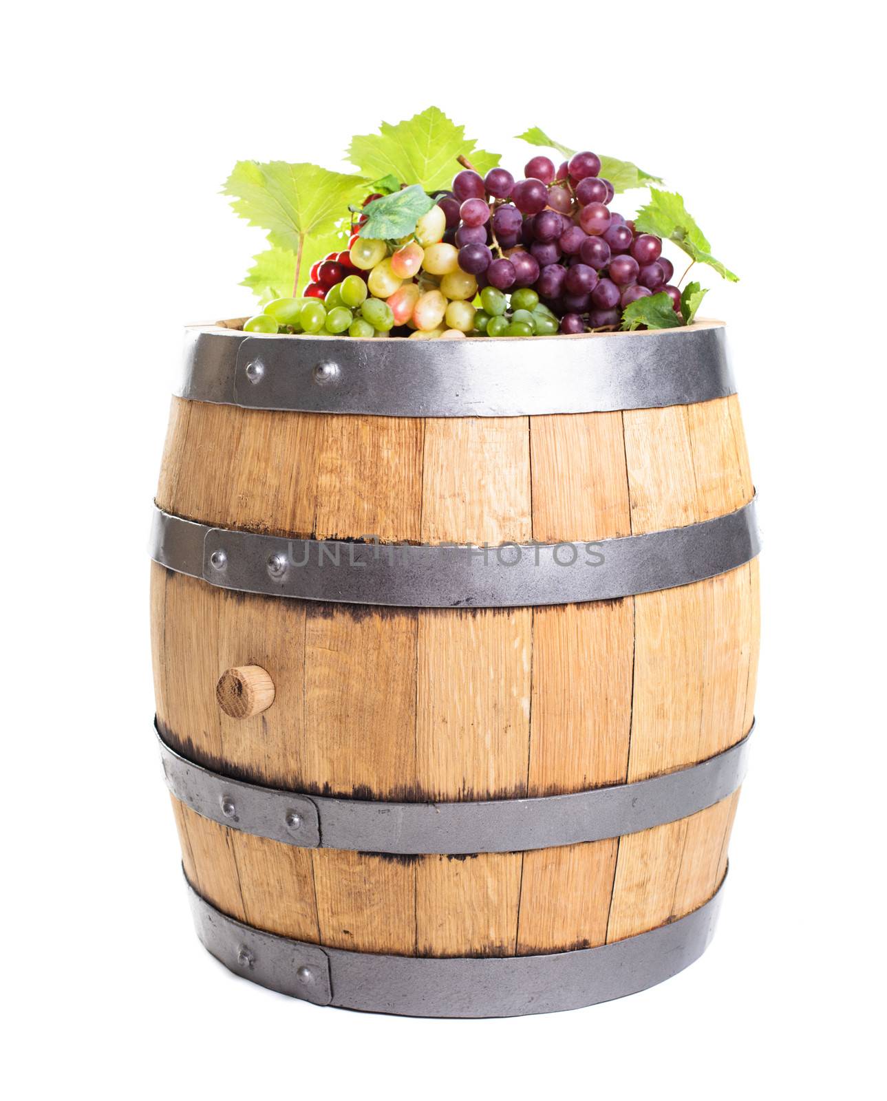 Grapes on wooden barrel with wine isolated on white